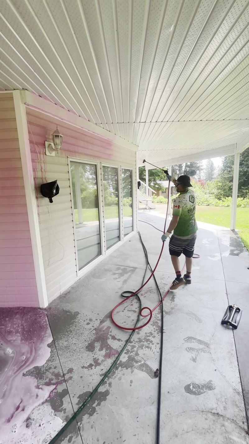 Grit & Grind team member cleaning exterior soffits