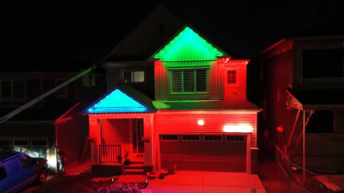 Home lit red and green for Christmas with permanent LED lights
