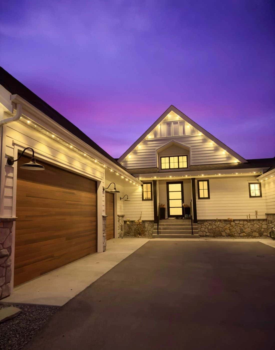24V permanent LED roofline lighting glowing warm white at twilight
