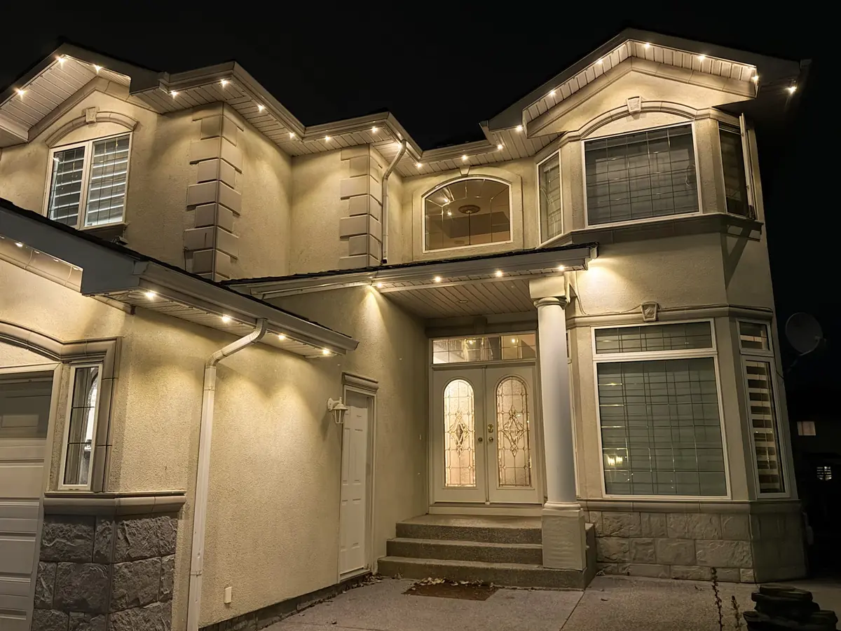 Stucco home with warm white architectural lighting