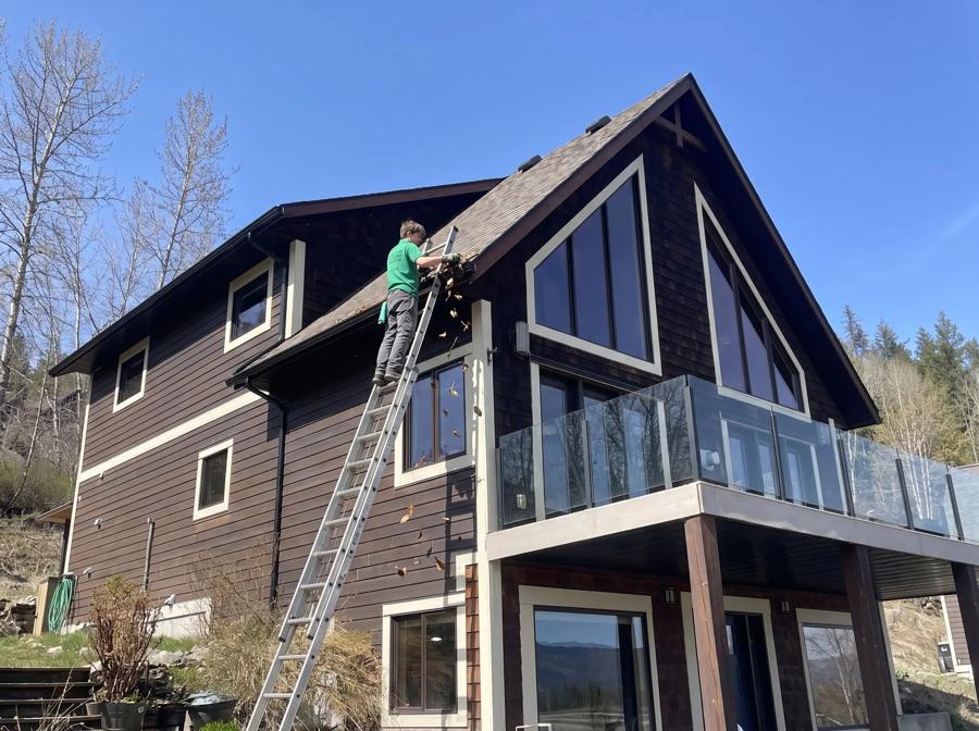 Gutter cleaning from a ladder